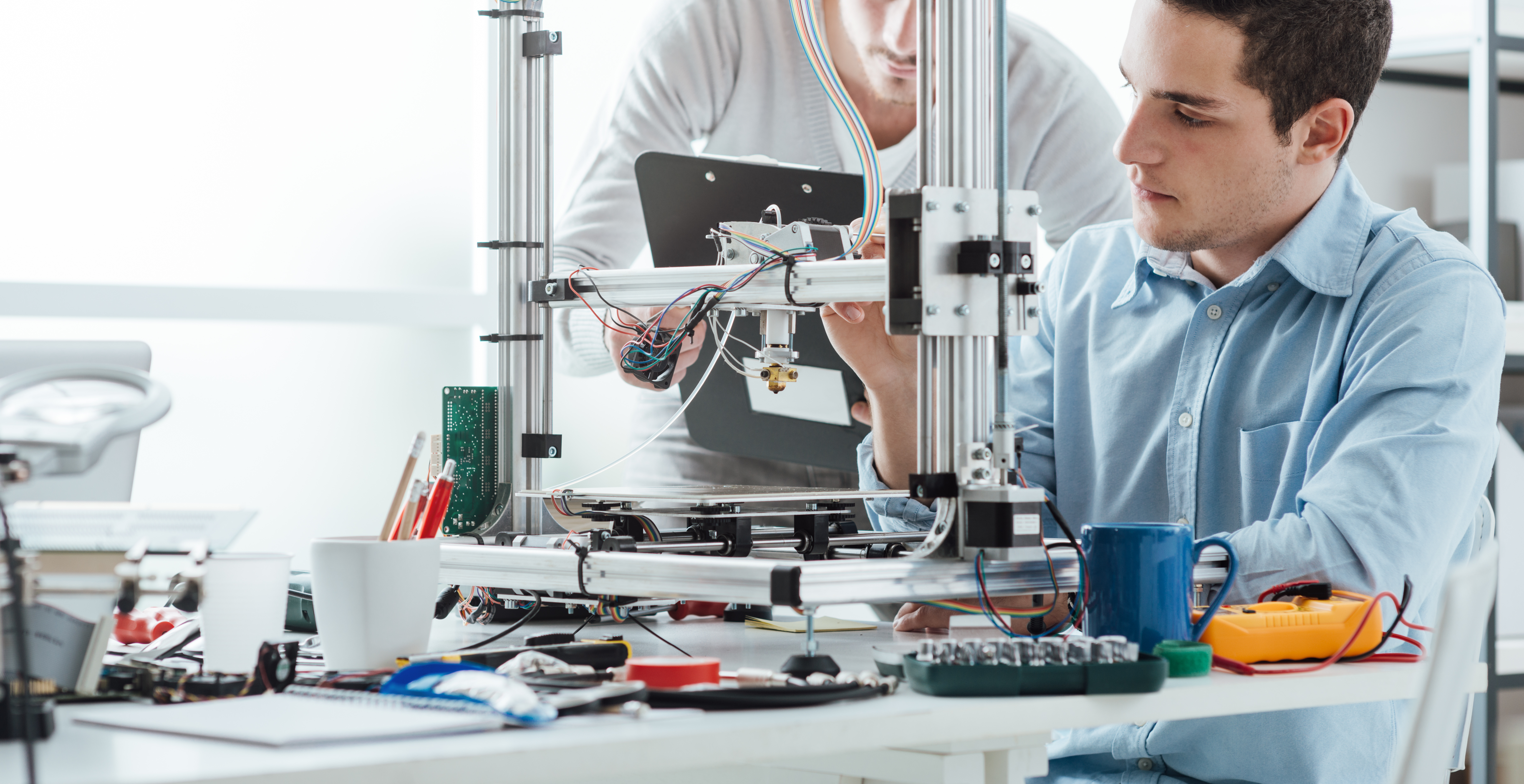Engineering students using an innovative 3D printer in the laboratory