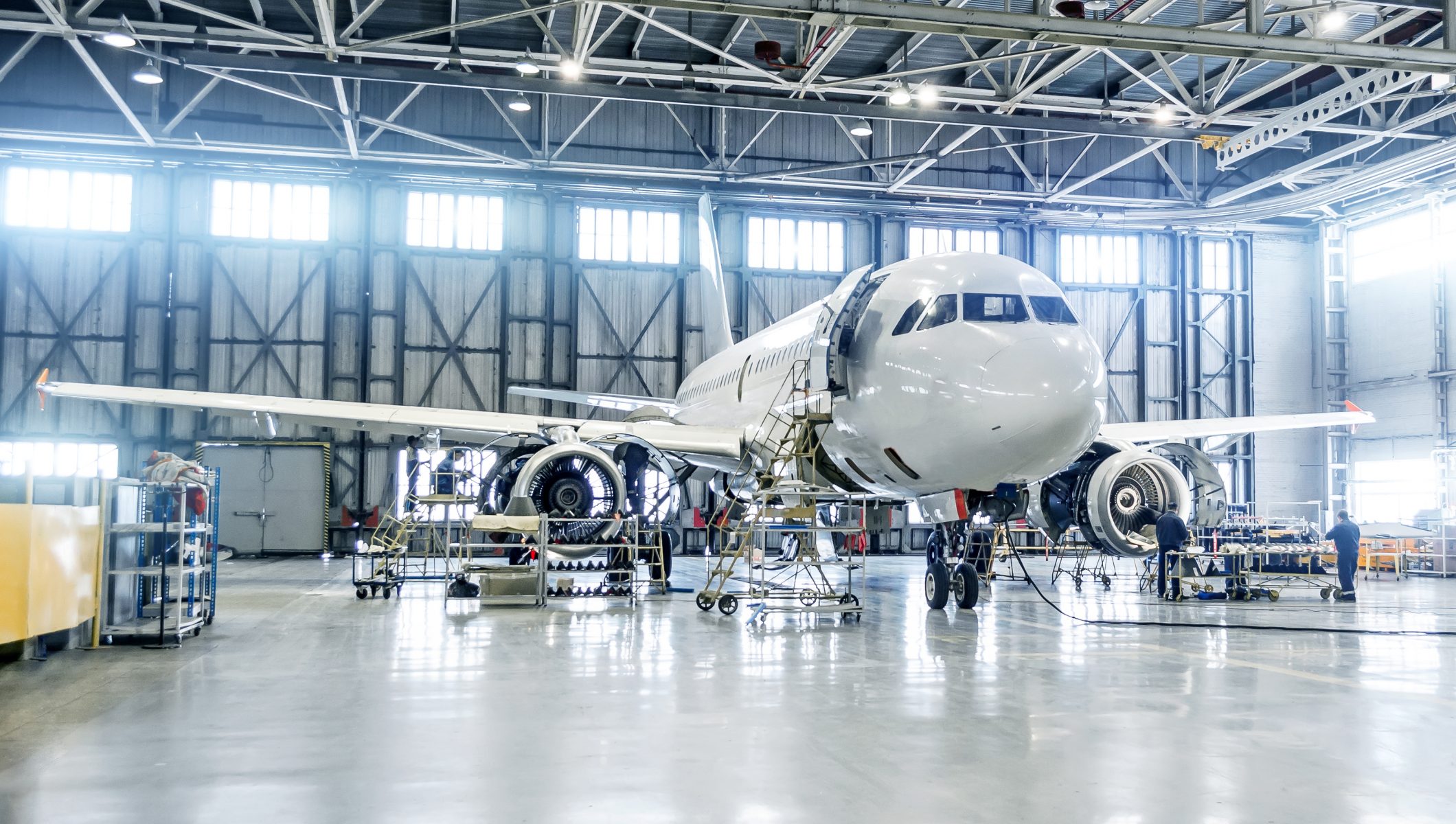 Passenger airplane on maintenance of engine and fuselage check repair in airport hangar